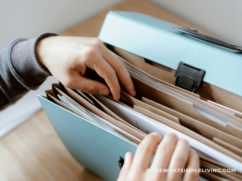 organizing paper in a home office with a file folder