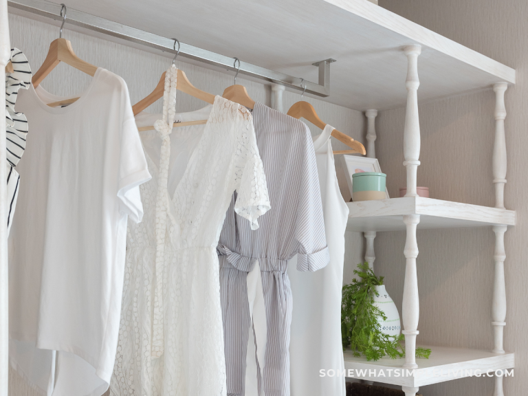 postpartum closet declutter: classic natural-colored clothes hanging in a closet