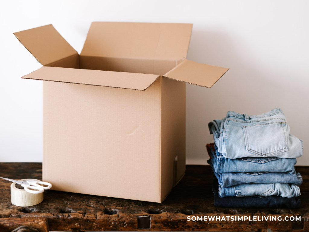 stack of denim next to a brown box