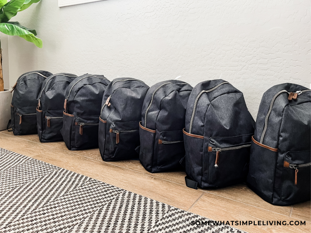 72 hour kit backpacks lined up along a wall