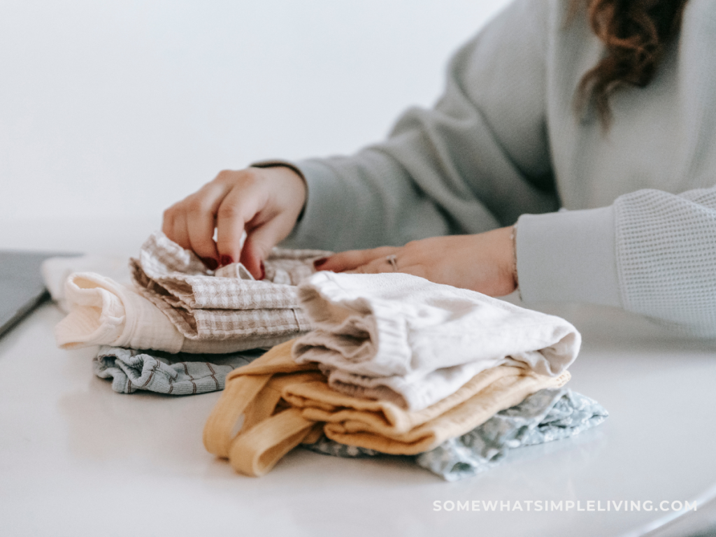woman folding kids' clothes