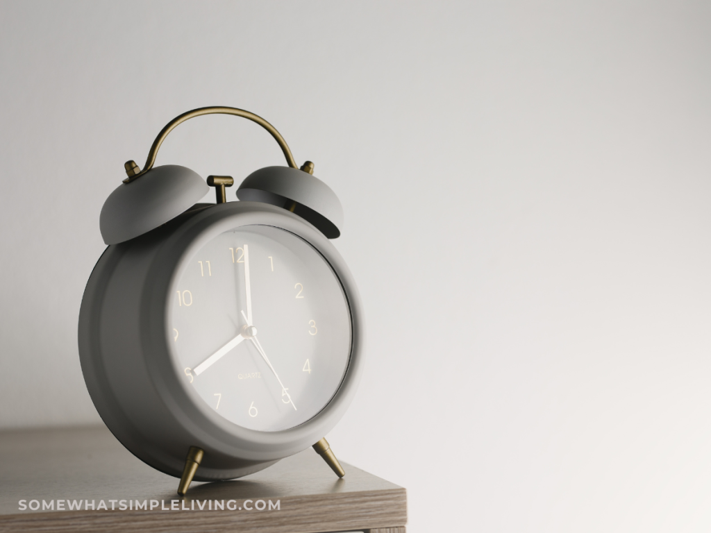 gray alarm clock on a wood table