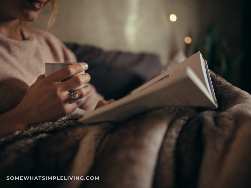 woman reading a book at night