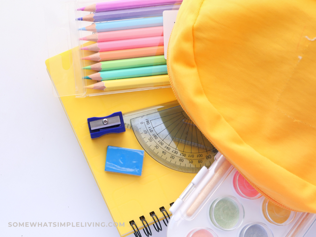 back to school supplies coming out of a backpack