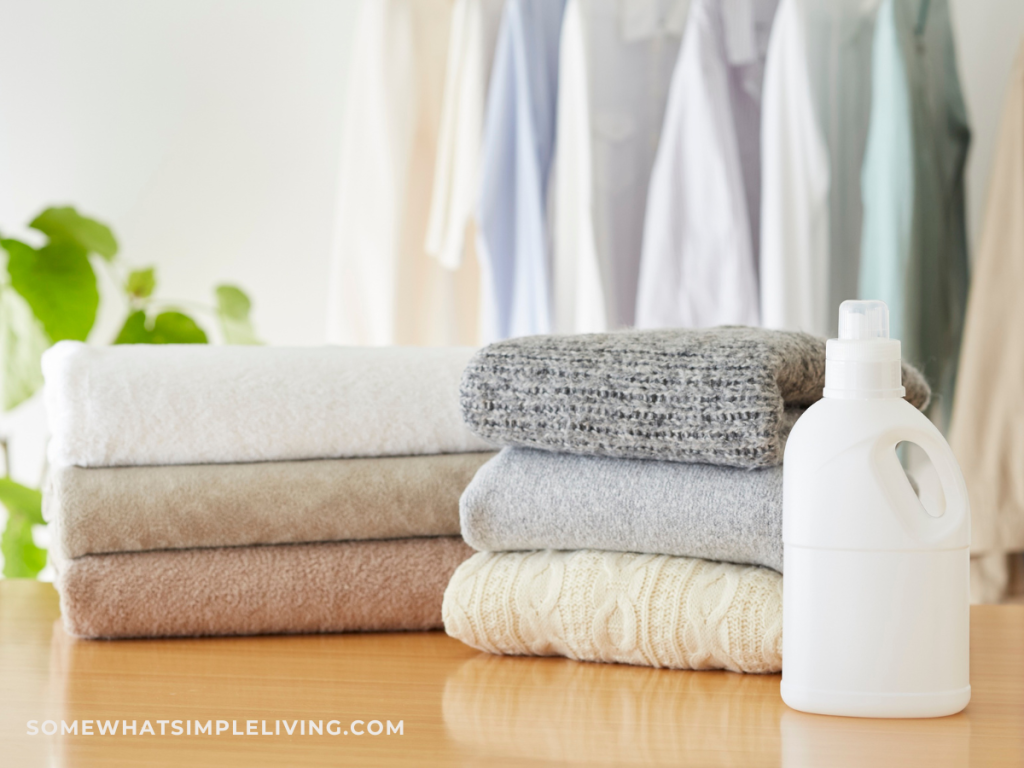cleaning supplies on a counter next to a stack of towels