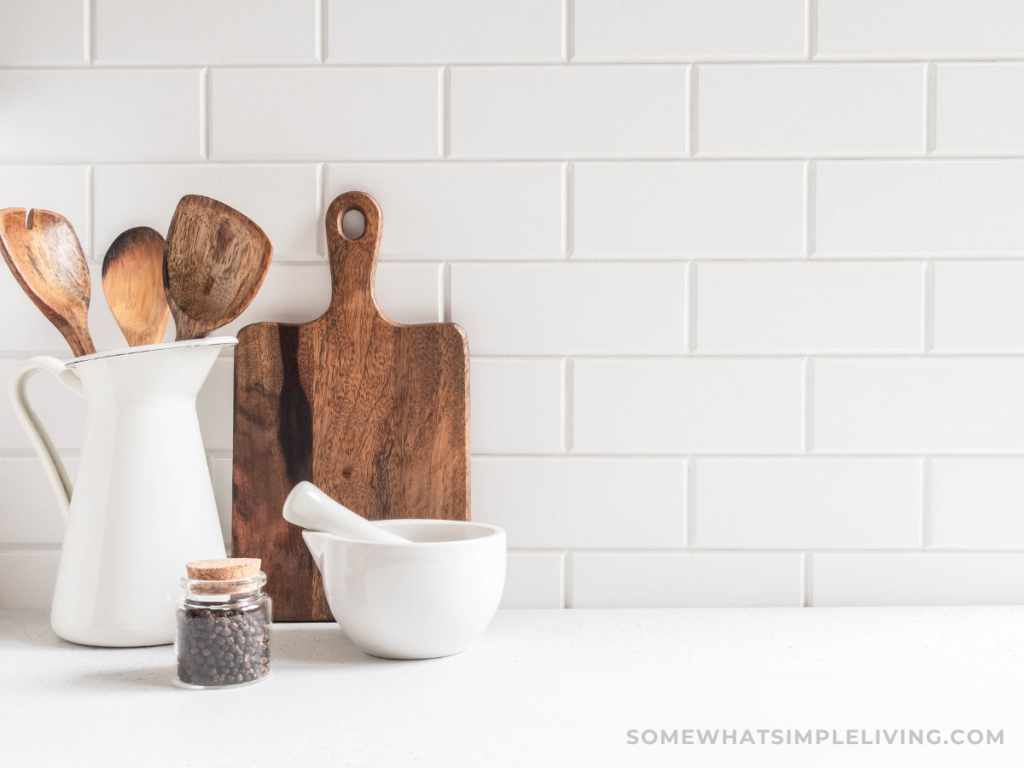white kitchen counter with wood utensils in a holder