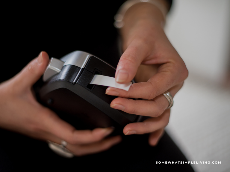 woman's hands holding a label maker