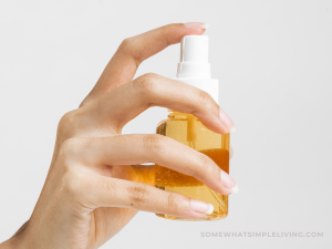 spraying a small bottle of air freshener