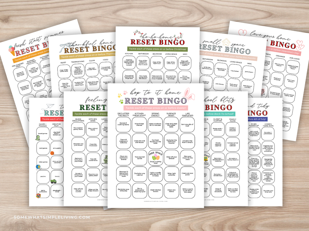 Home reset bingo cards laid out on a wood baackground