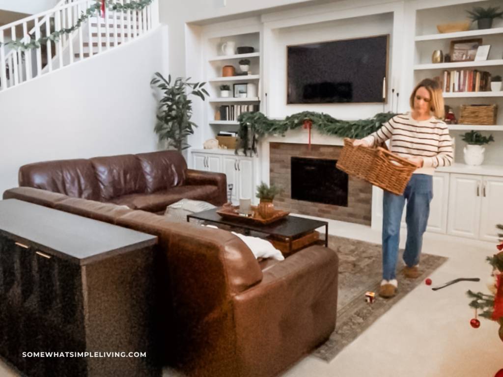 woman holding basket in the family room picking up toys and stray items