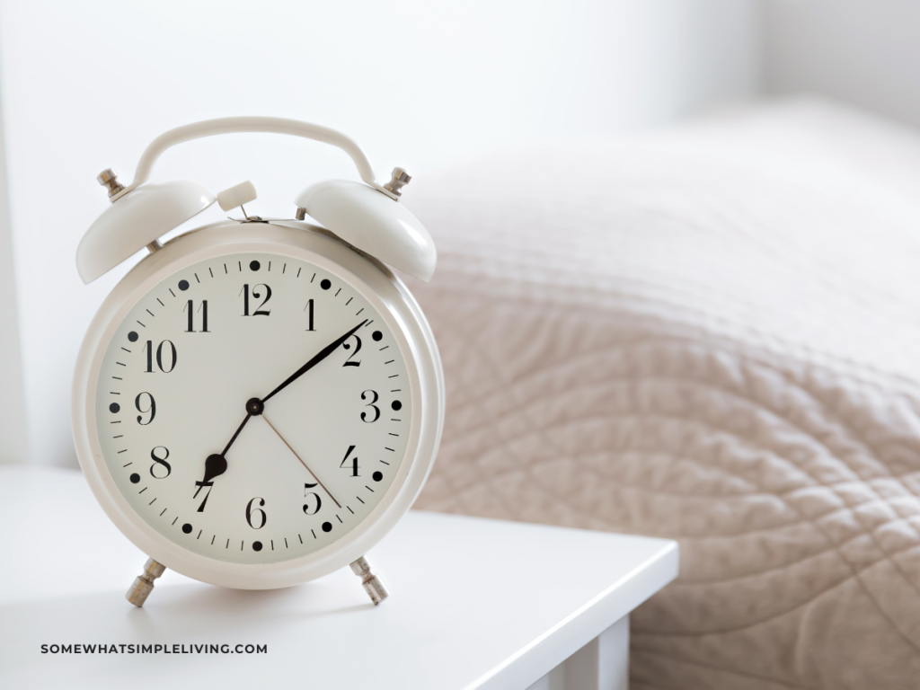 white timer/ alarm clock on a bedside table