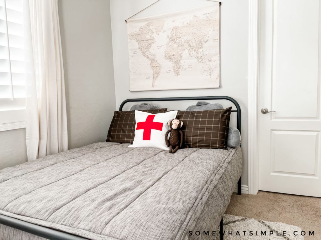 mason's bedroom with gray bedding and a monkey pillow