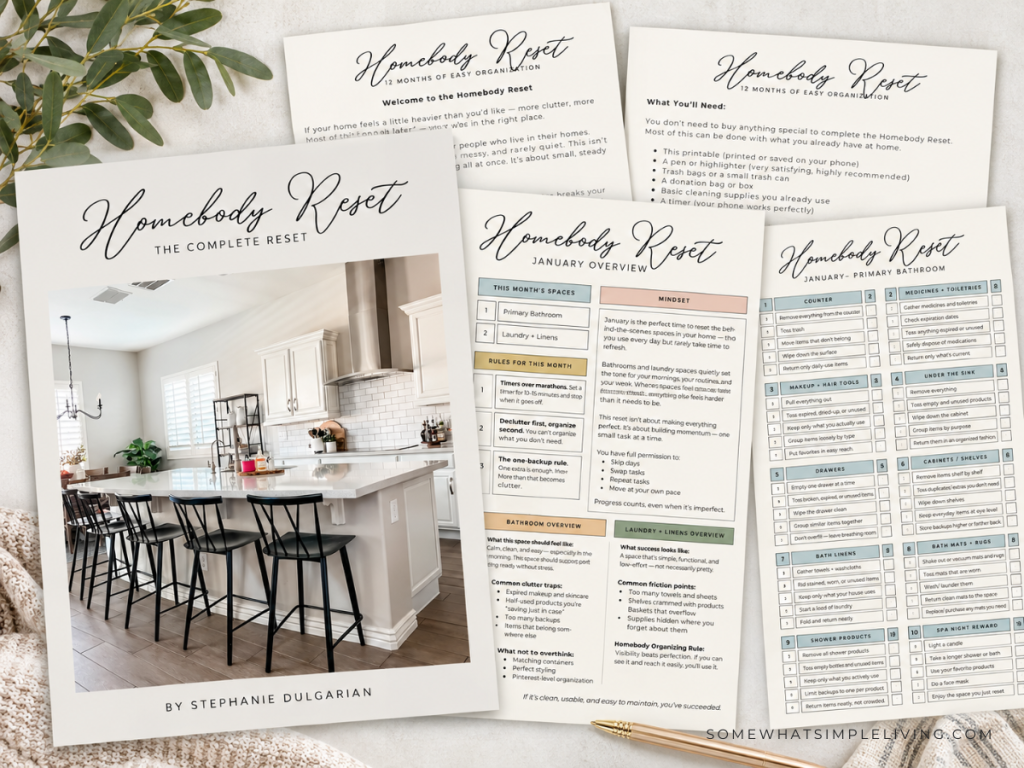homebody reset checklists fanned out on a beige background